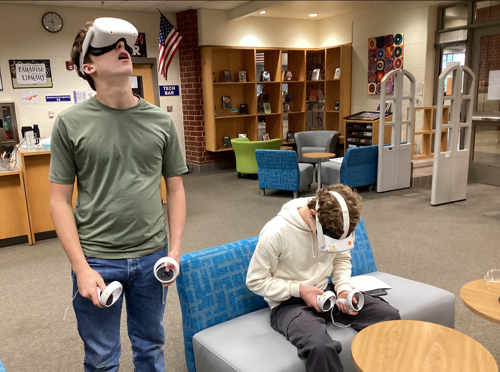 Students in a library participate in a constellation station project.
