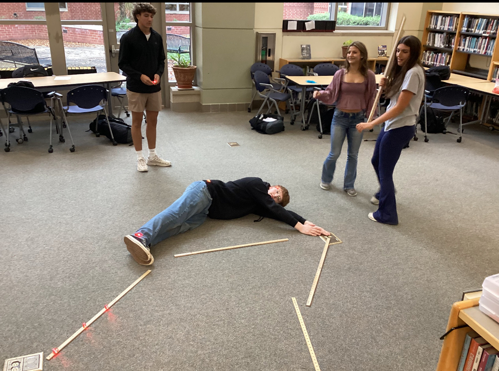 Students in a library participate in a constellation station project.