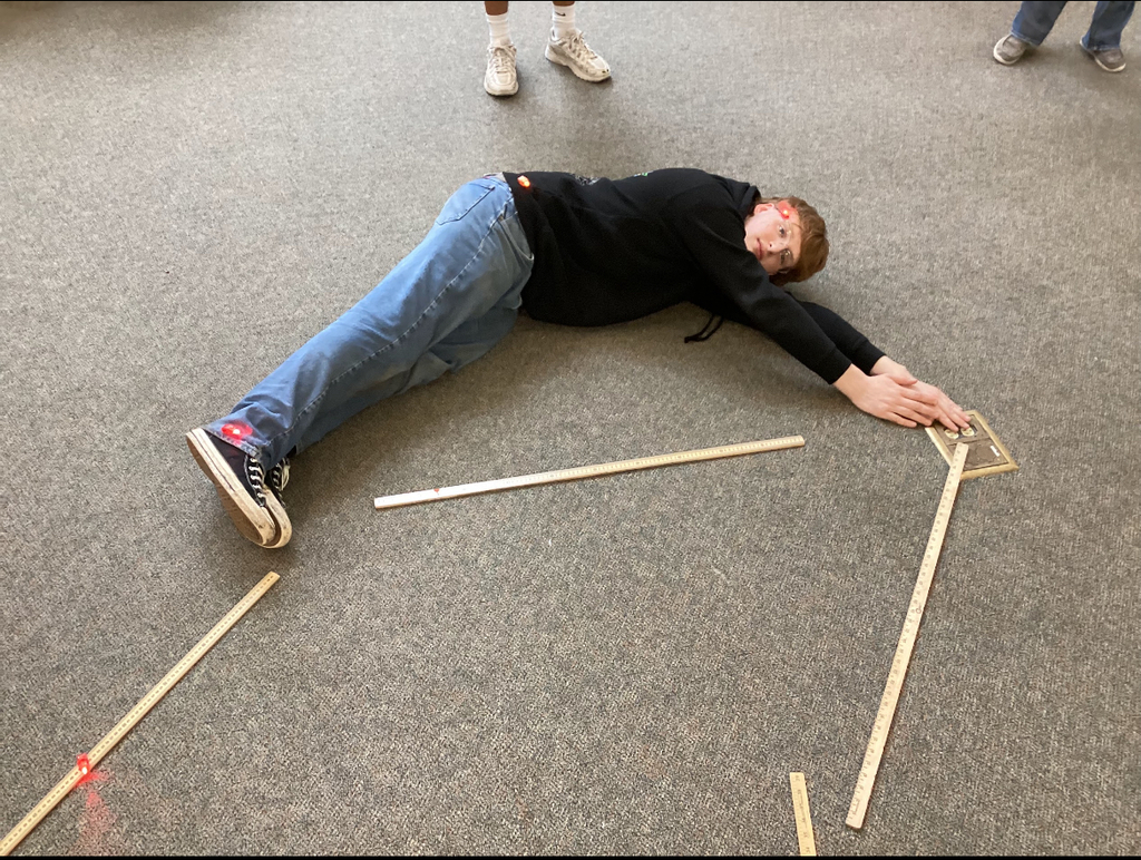 Students in a library participate in a constellation station project.