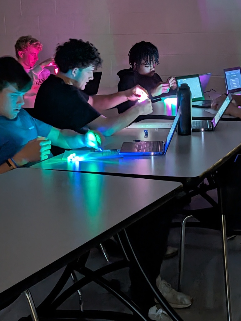 Students in a library participate in a constellation station project.