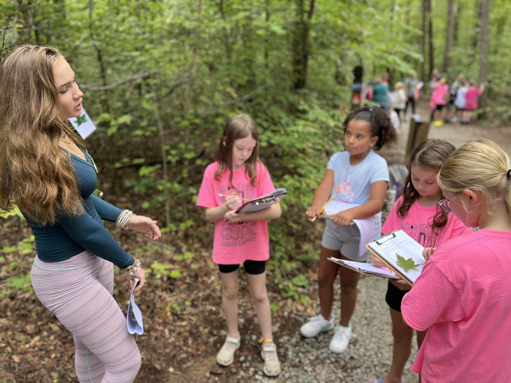 A high school student talks to younger students about trees. 