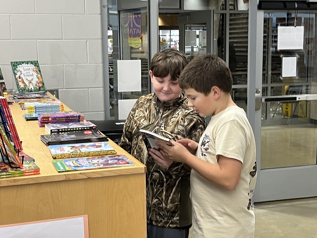 Students shop at a middle school book fair. 
