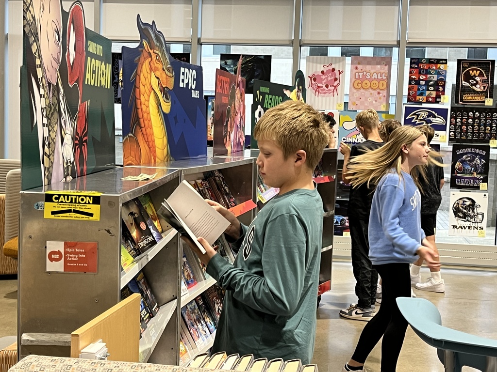 Students shop at a middle school book fair. 