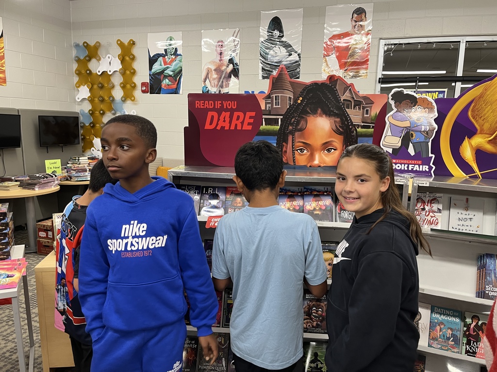 Students shop at a middle school book fair. 