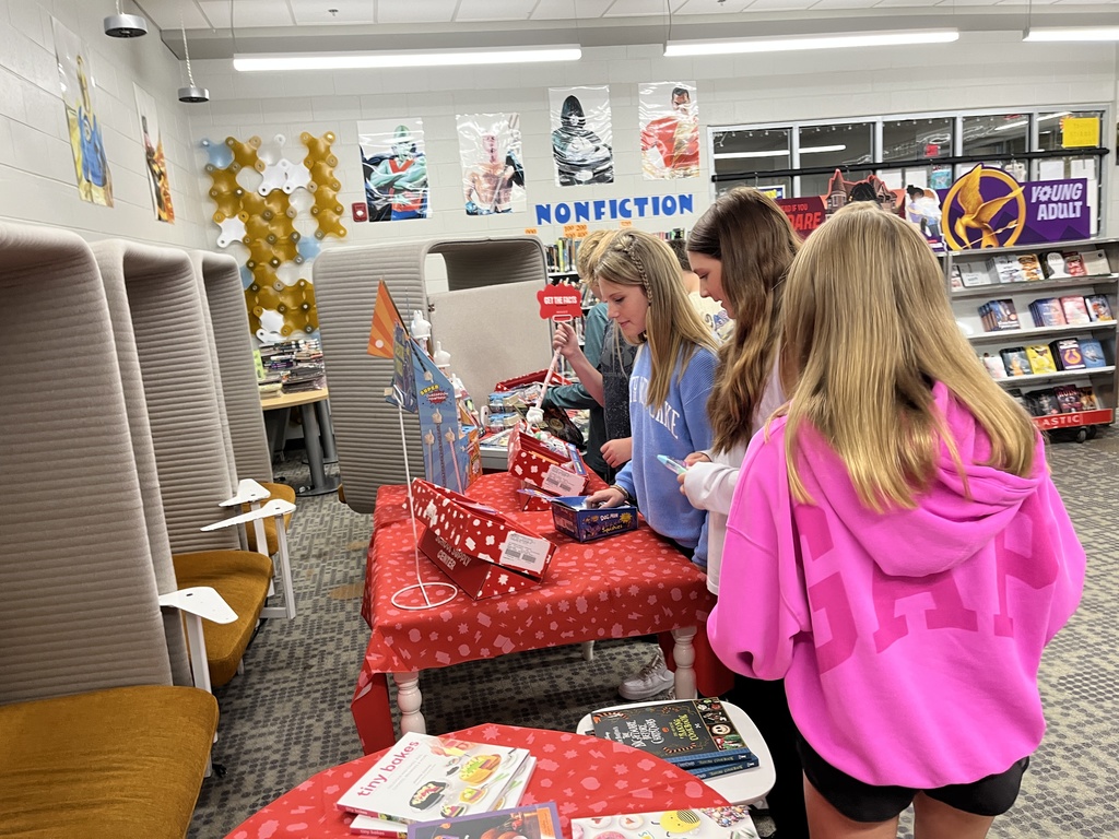 Students shop at a middle school book fair. 