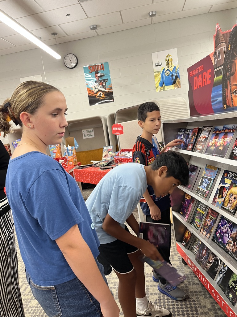 Students shop at a middle school book fair. 