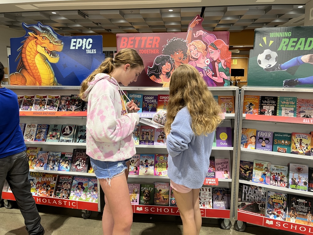 Students shop at a middle school book fair. 