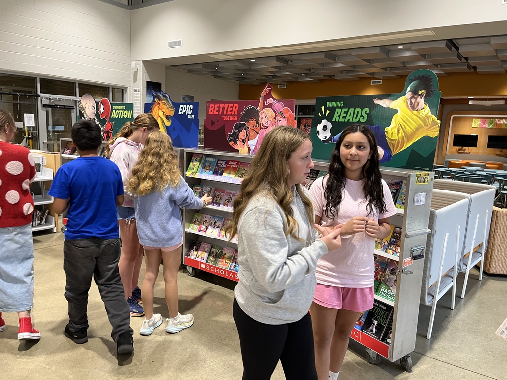 Students shop at a middle school book fair. 