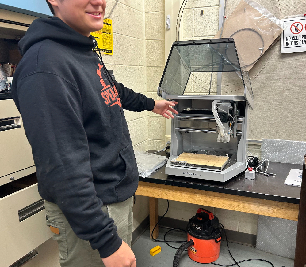A student shows off an engineering lab tool.