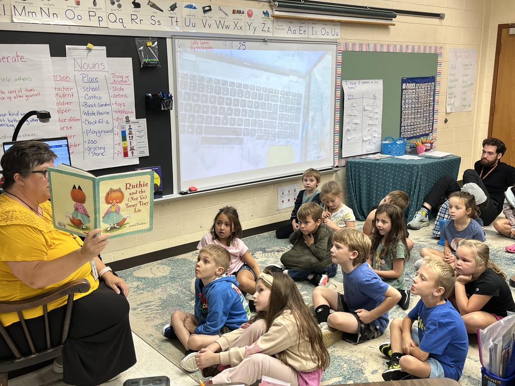 A teacher reads a book to children during storytime. 