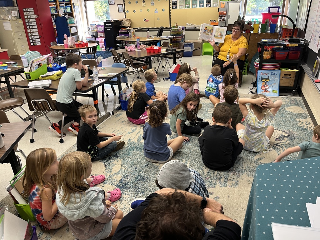 A teacher reads a book to children during storytime. 