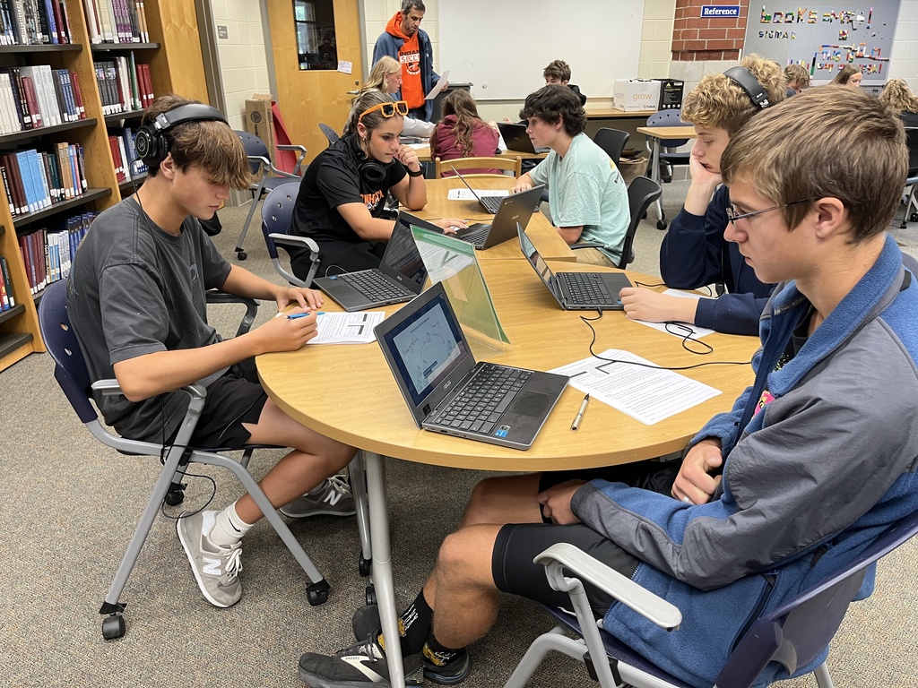 A group of students work at a station dealing with migration.