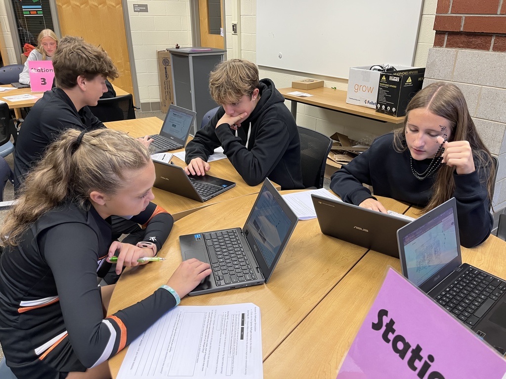 A group of students work at a station dealing with migration.