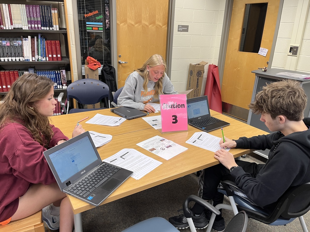 A group of students work at a station dealing with migration.