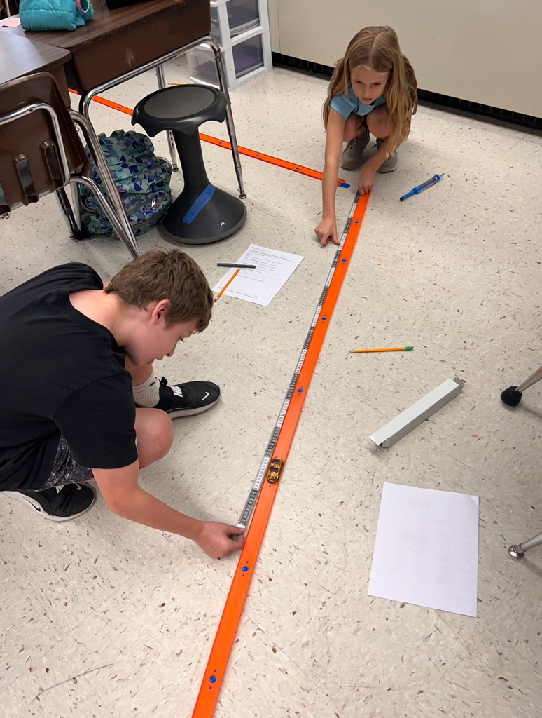Students conduct an experiment to investigate whether mass affects motion.