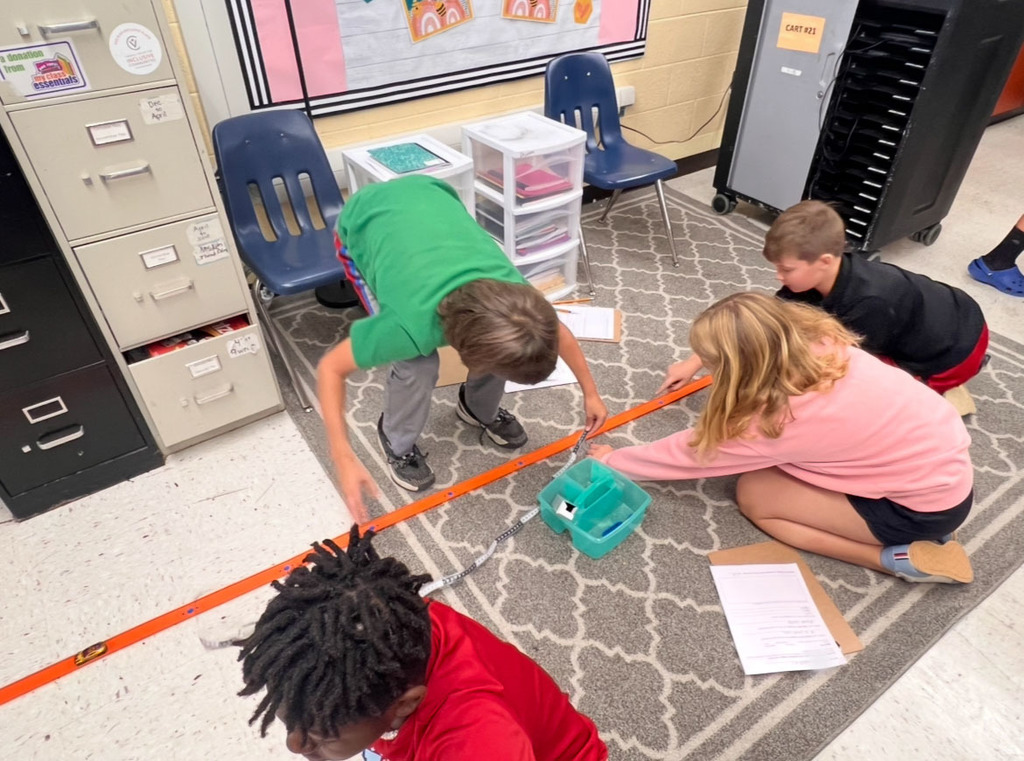 Students conduct an experiment to investigate whether mass affects motion.