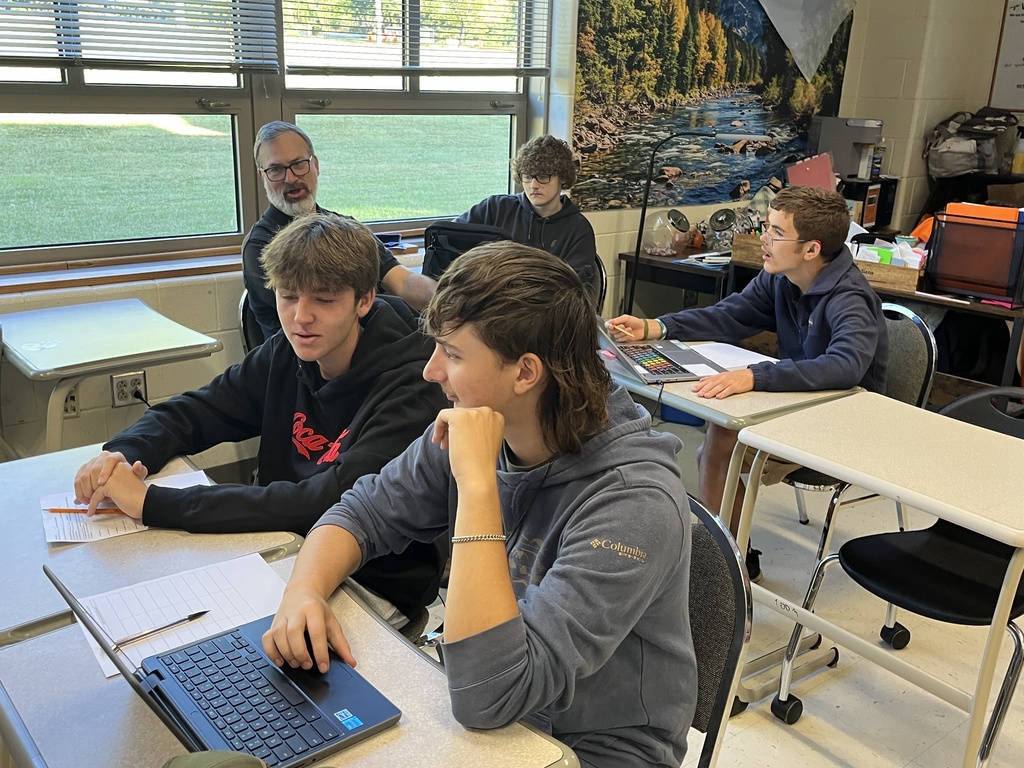 Students work in groups on a project about the Bill of RIghts. 