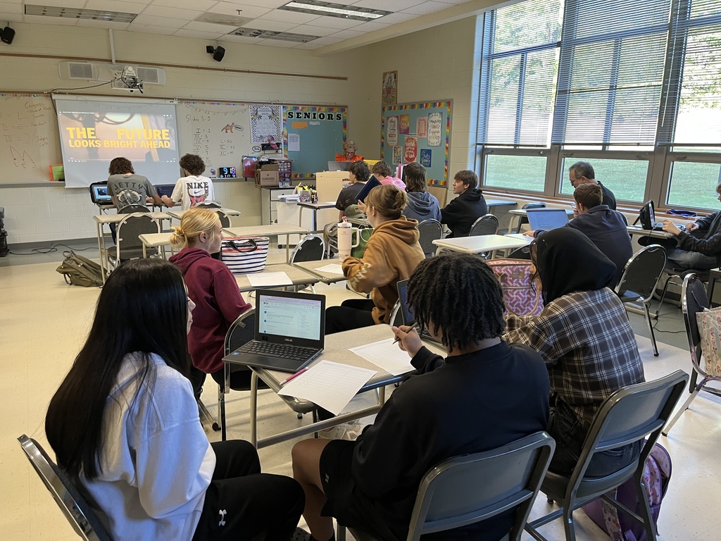 Students work in groups on a project about the Bill of RIghts. 