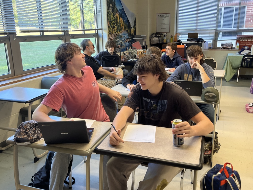 Students work in groups on a project about the Bill of RIghts. 