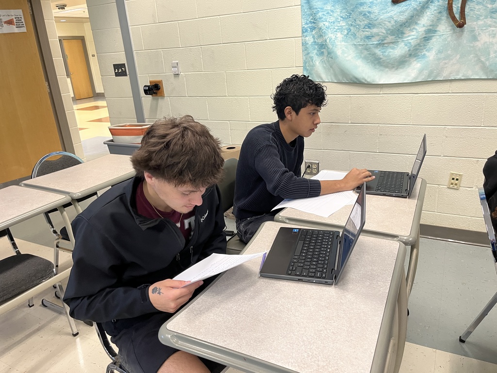 Students work in groups on a project about the Bill of RIghts. 