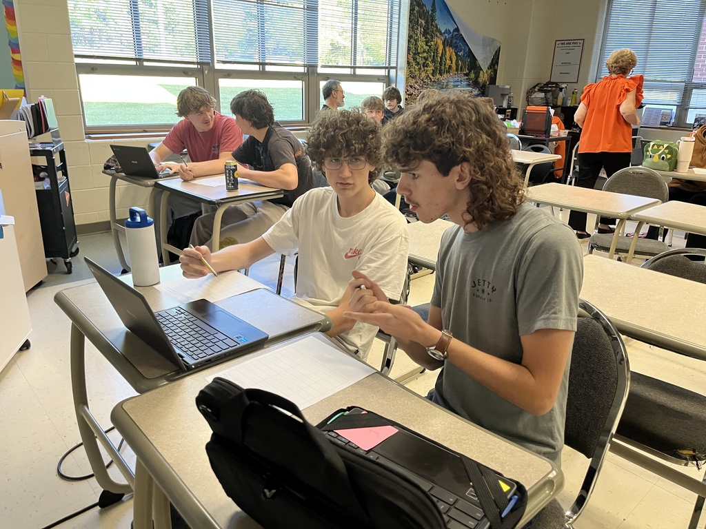 Students work in groups on a project about the Bill of RIghts. 