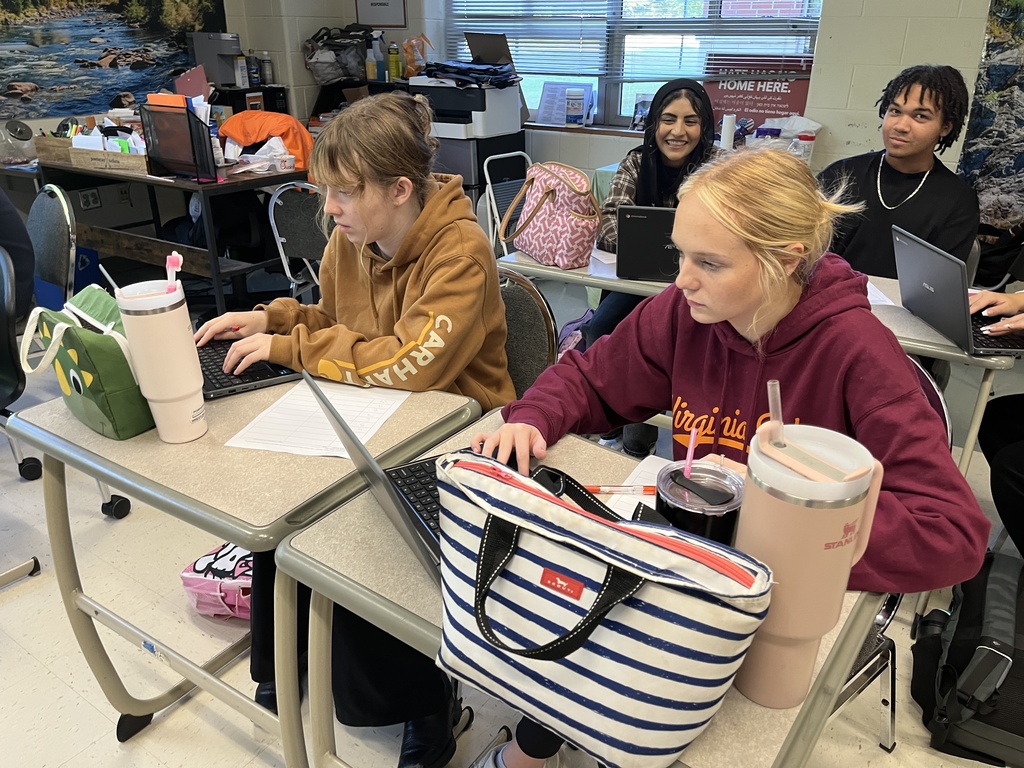 Students work in groups on a project about the Bill of RIghts. 