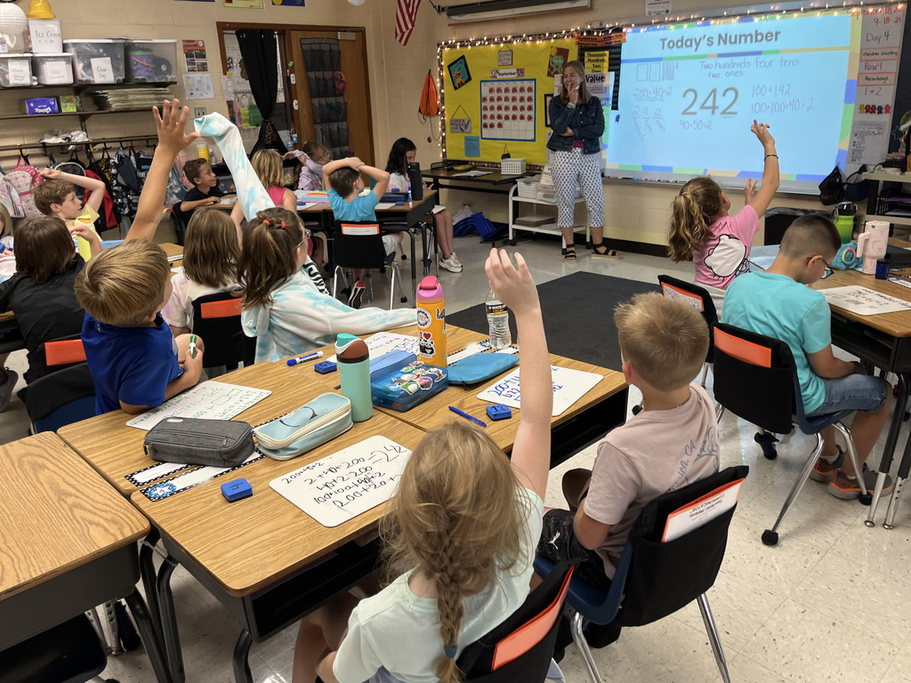 Students in a class explore all the different ways to represent a number with their teacher.