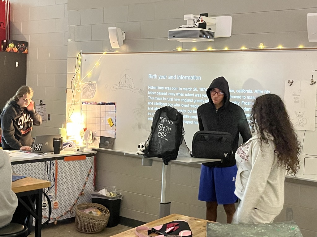 Students Present a poet tombstone project in art class. 