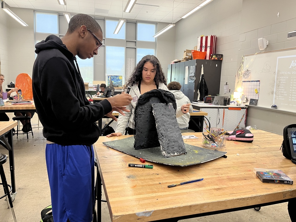 Students work on a poet tombstone project in art class. 