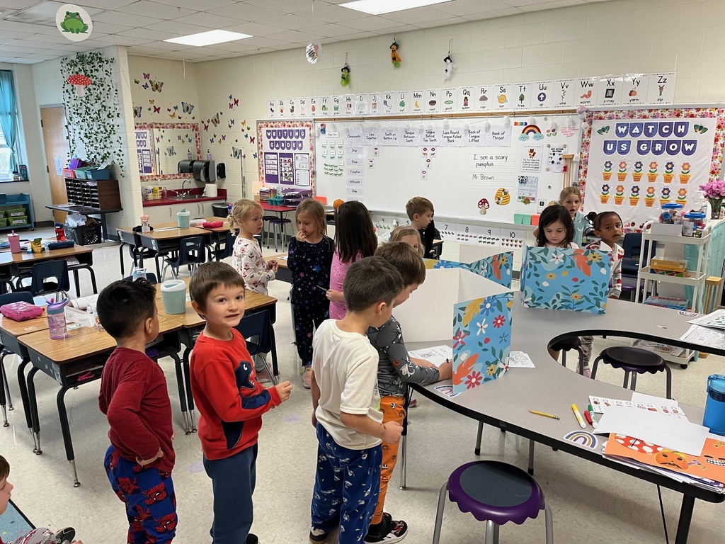 Kindergarteners line up to vote in a class election.
