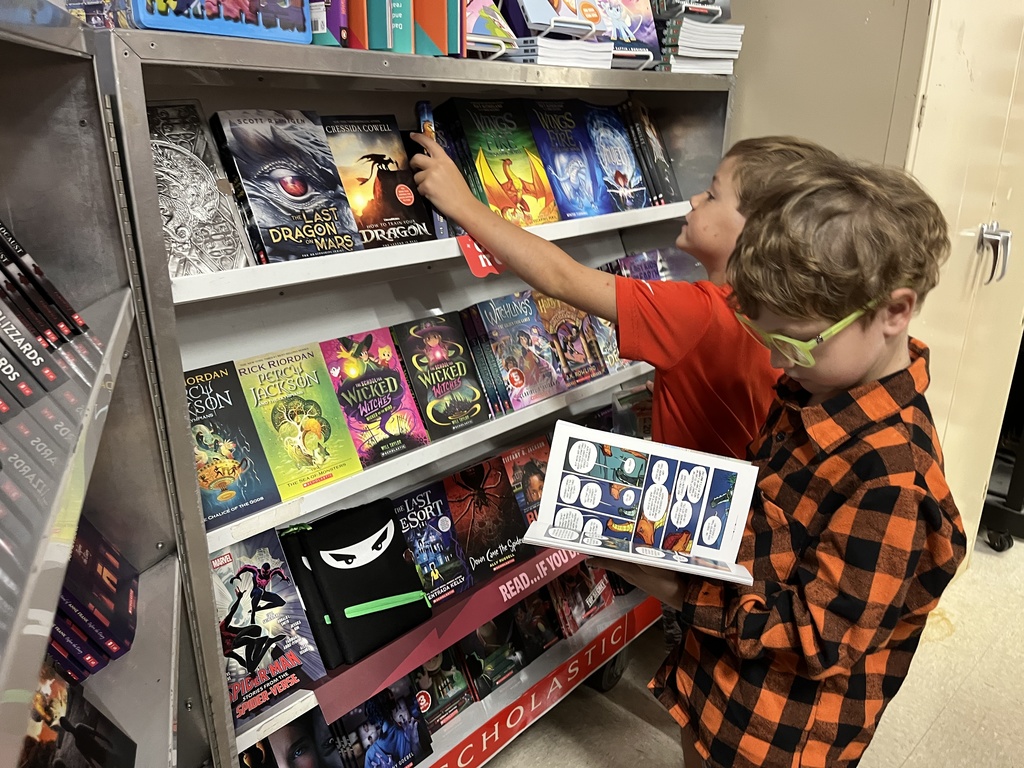 Students search through merchandise at a school book fair. 