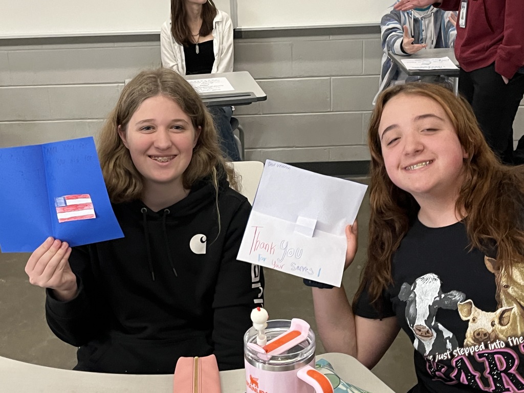 Students make Veterans Day cards for veterans.