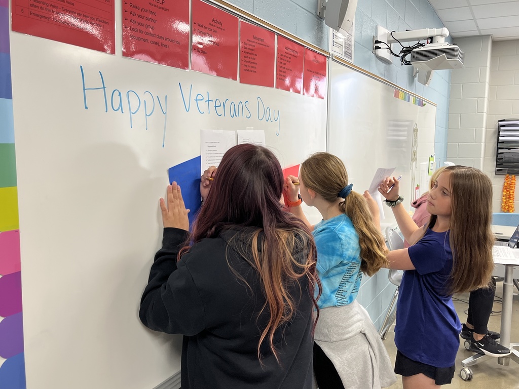 Students make Veterans Day cards for veterans.