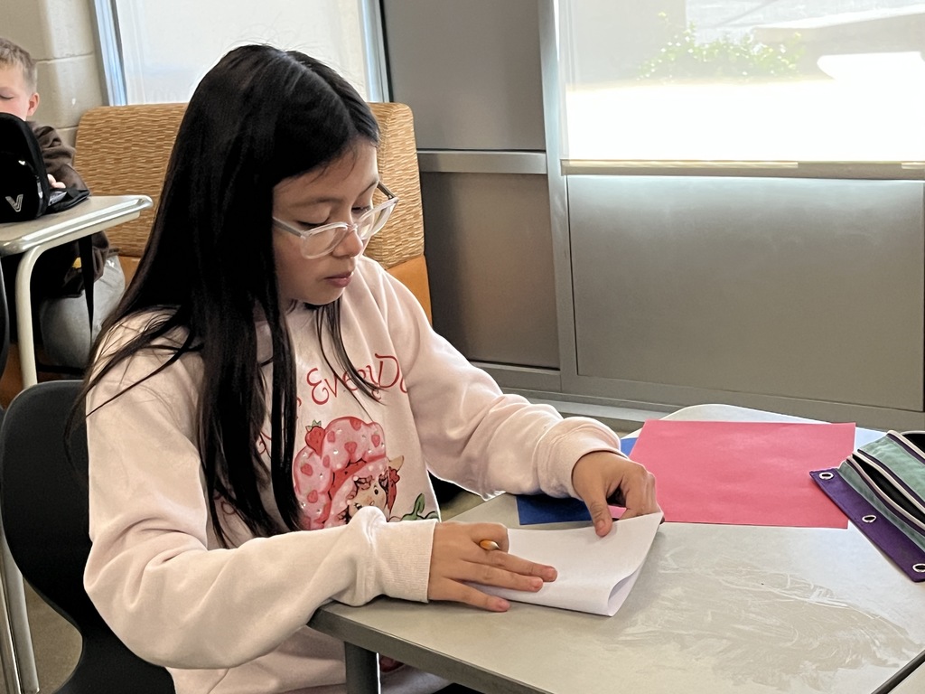 A student makes a Veterans Day card for a veteran.