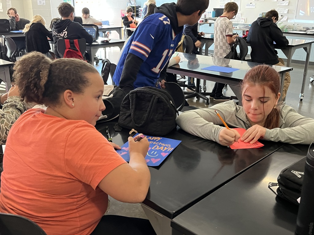 Students make Veterans Day cards for veterans.
