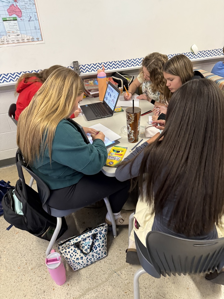 Students make Veterans Day cards for veterans.