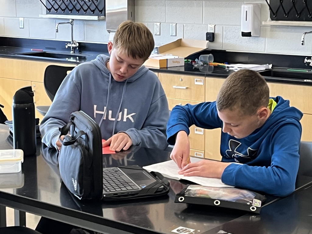 Students make Veterans Day cards for veterans.