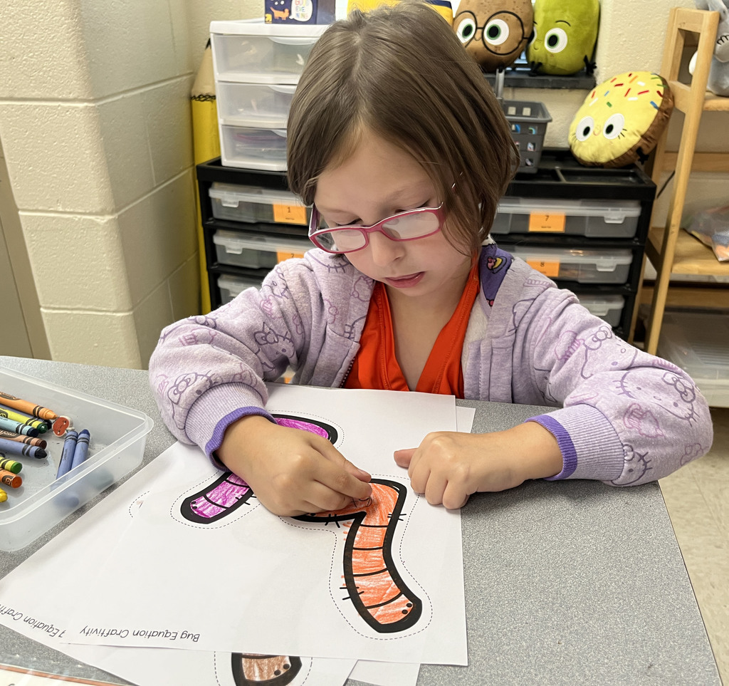 A child works on a math bug activity. 