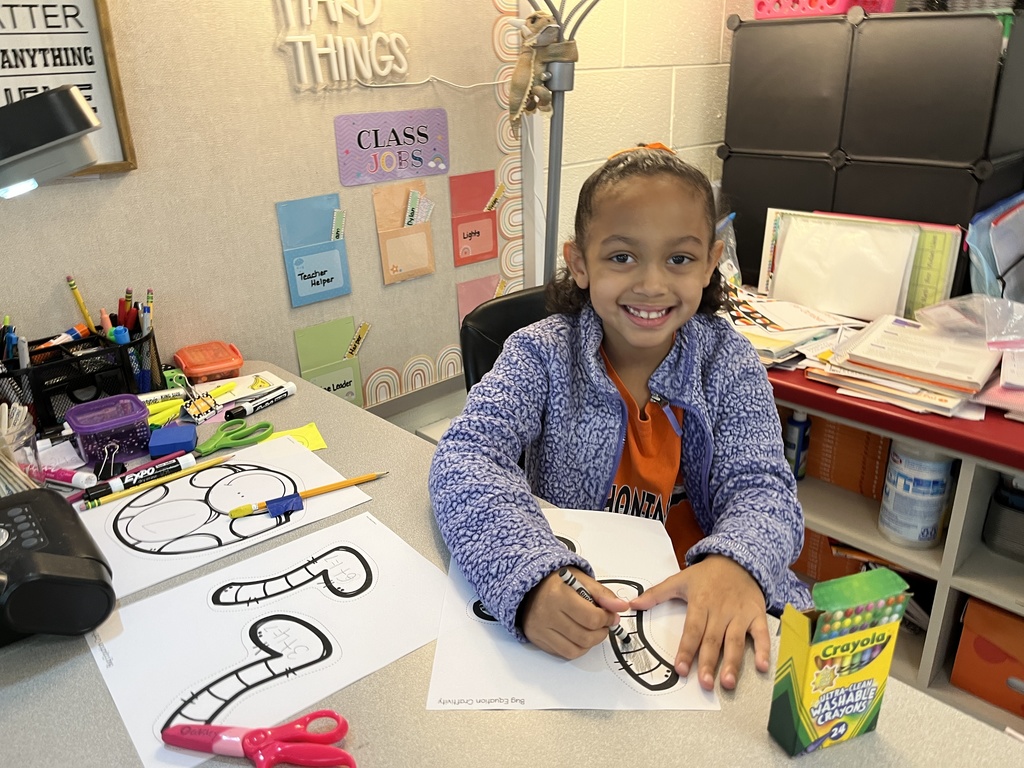 A child works on a math bug activity. 