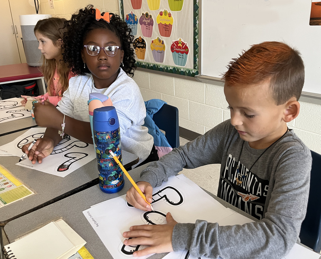 Children work on a math bug activity. 
