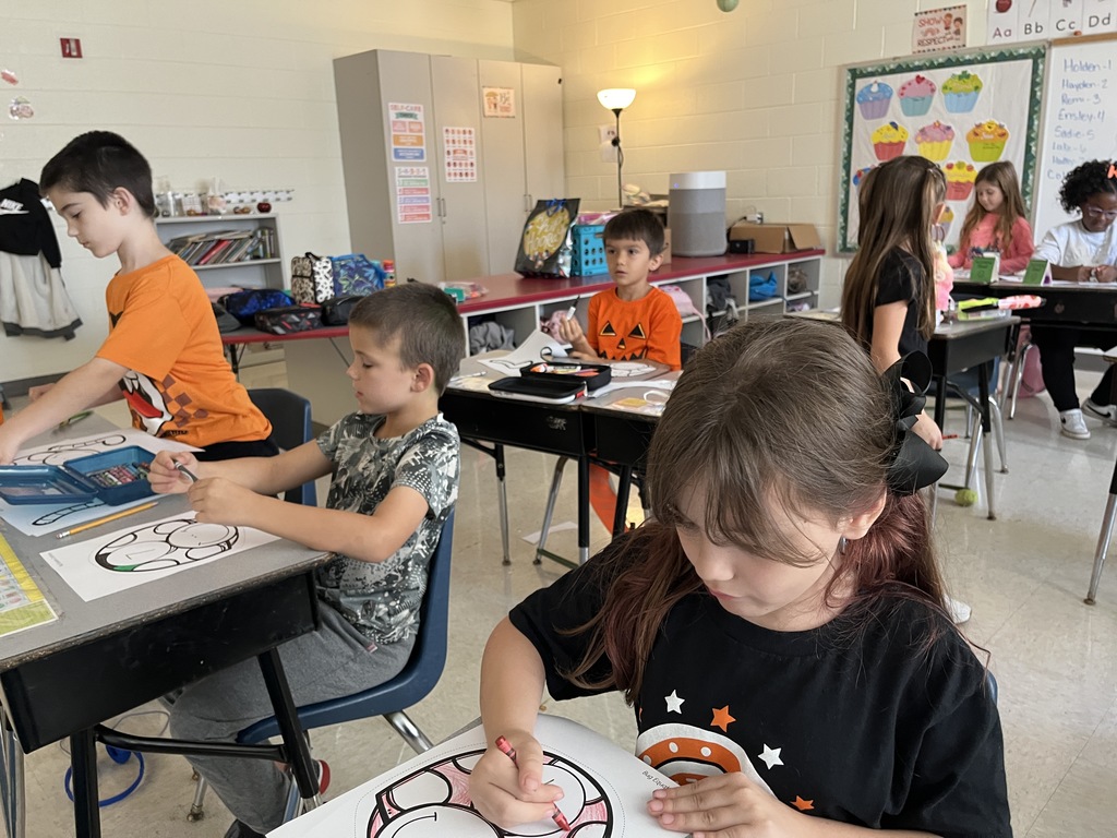 Children work on a math bug activity. 