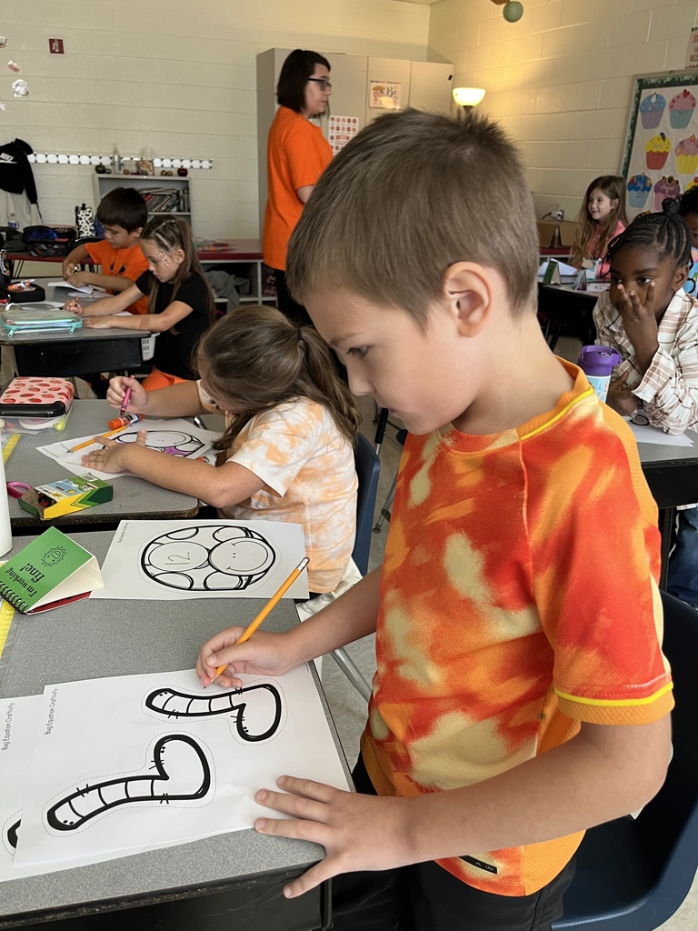 Children work on a math bug activity. 