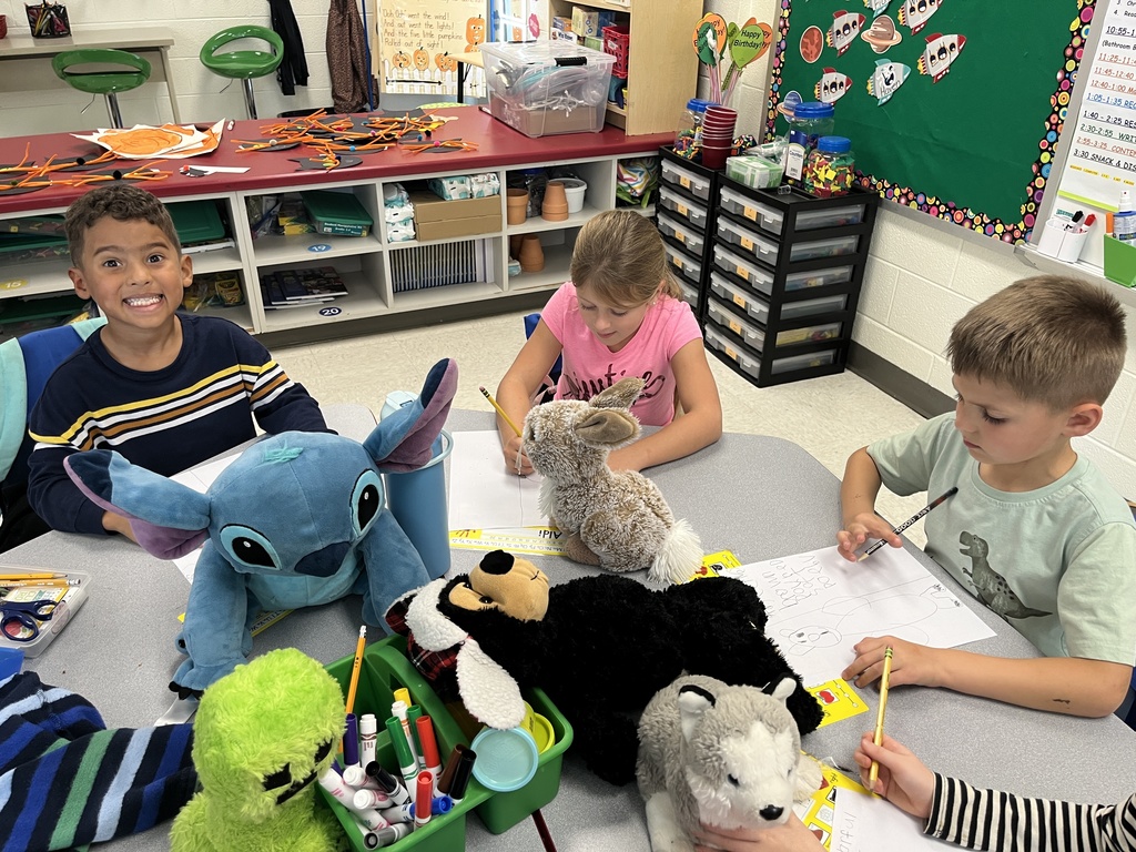 Students use  a stuffie they brought to school for a writing assignment. 