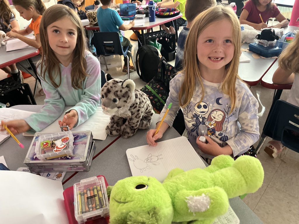 Students use  a stuffie they brought to school for a writing assignment. 