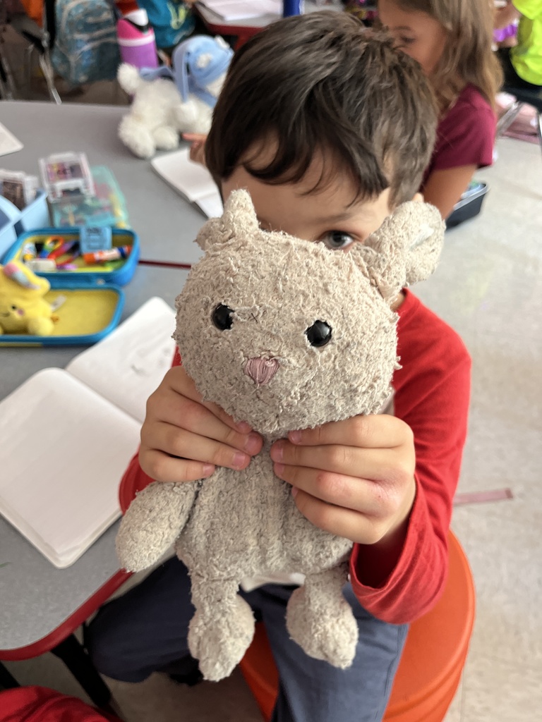 A student shows a stuffie he brought to school.