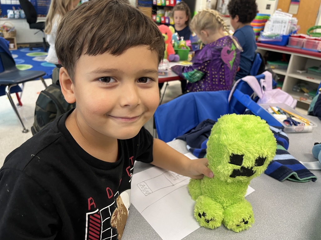 A student shows a stuffie he brought to school.