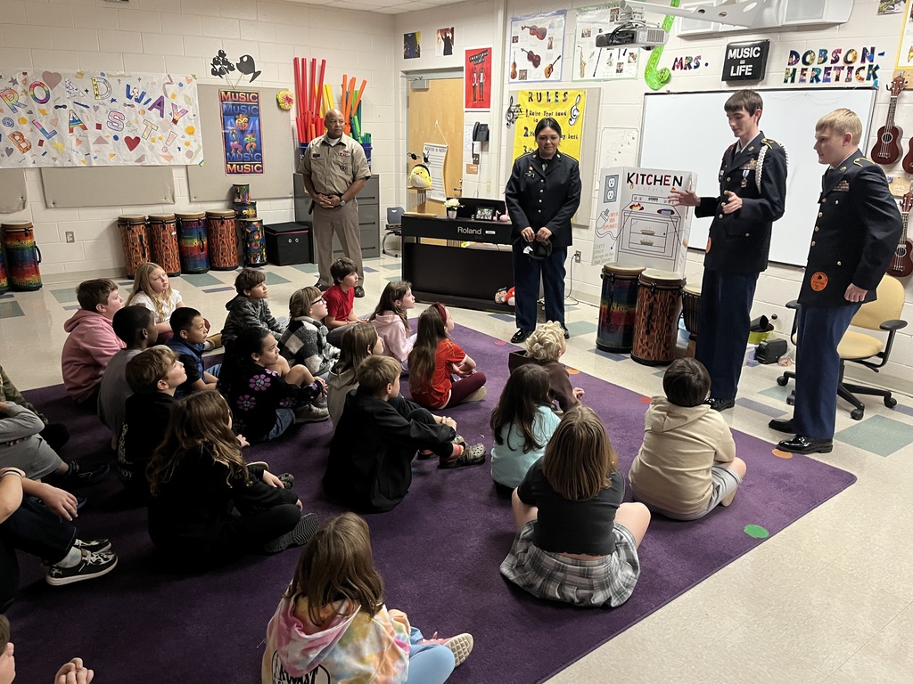 A group of students listen to a fire safety presentation given by JROTC cadets. 