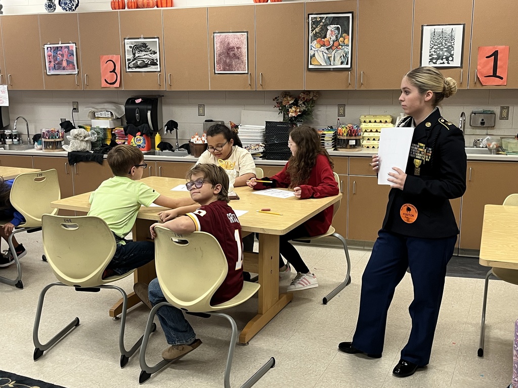 JROTC cadets help students work on fire safety escape plans.