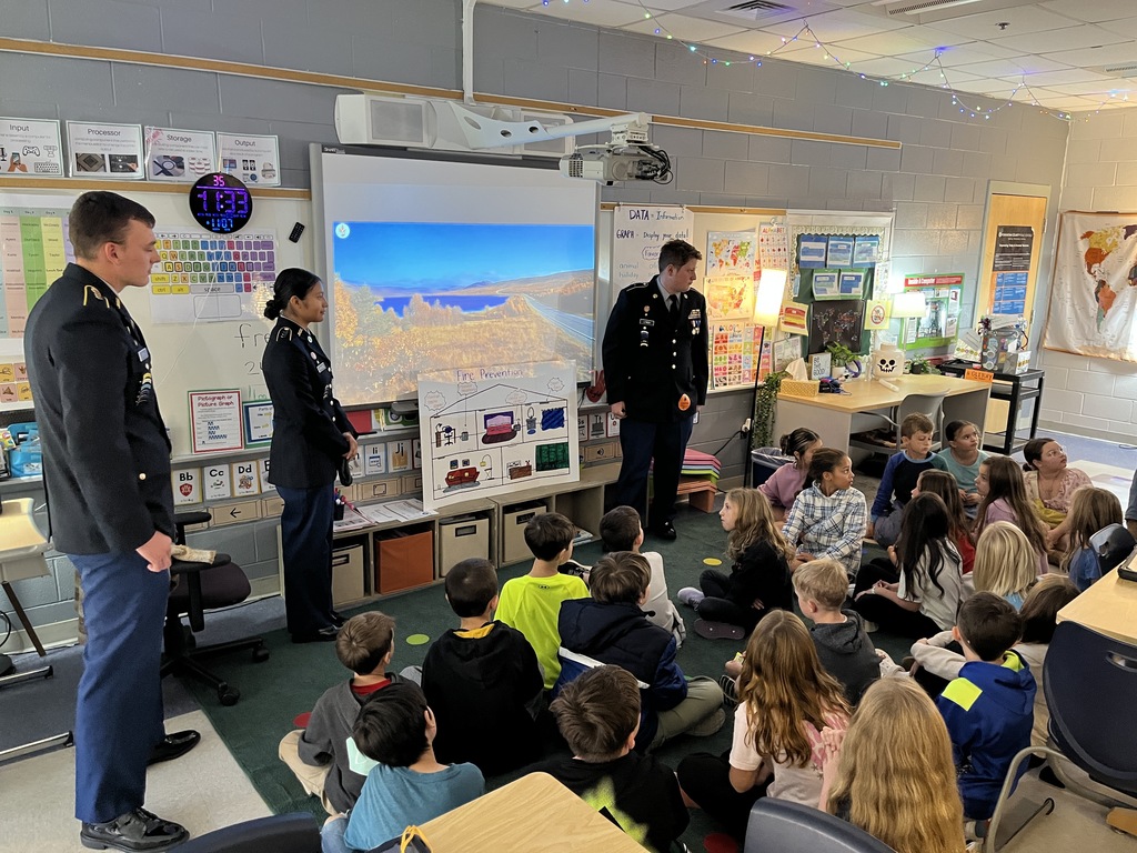 A group of students listen to a fire safety presentation given by JROTC cadets. 