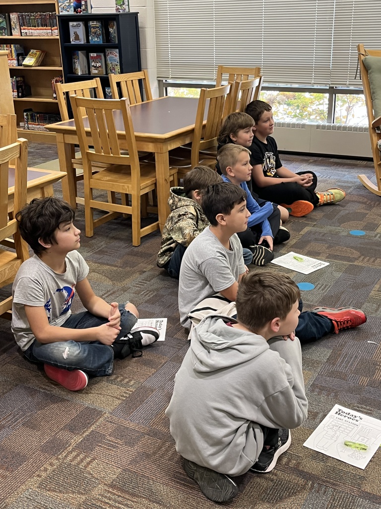 A group of students listen to a fire safety presentation given by JROTC cadets. 